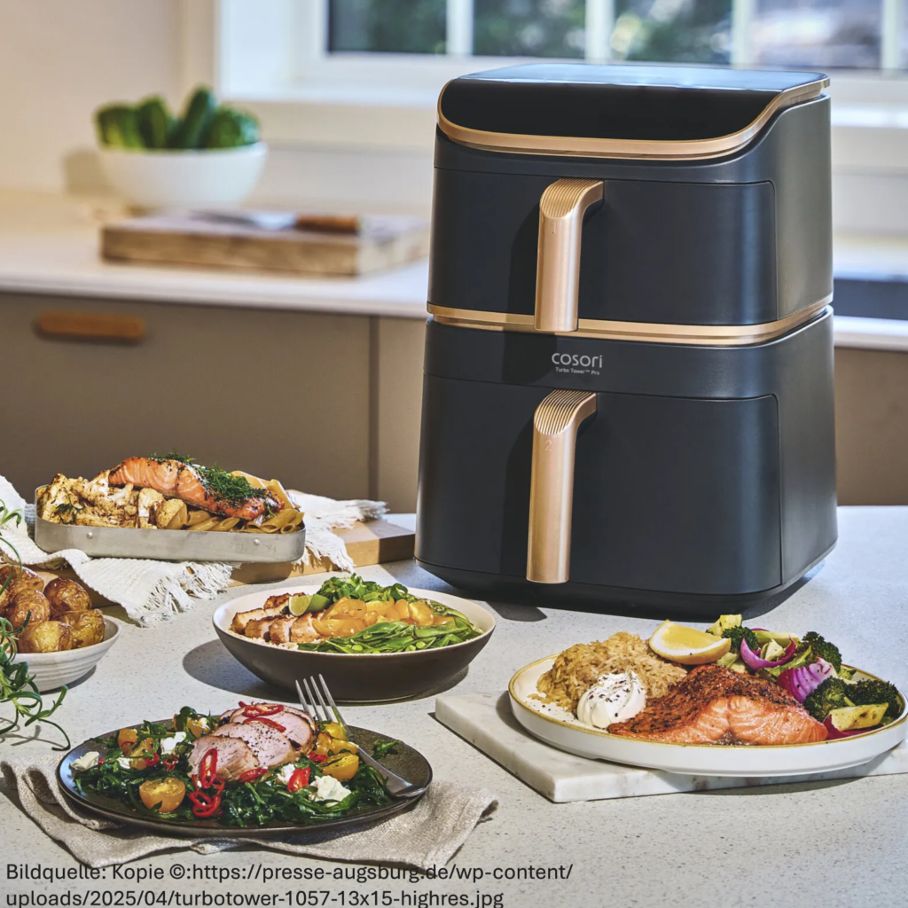 Bild zeigt Cosori Turbo Tower Pro Smart hinter diversen zubereiteten Speisen